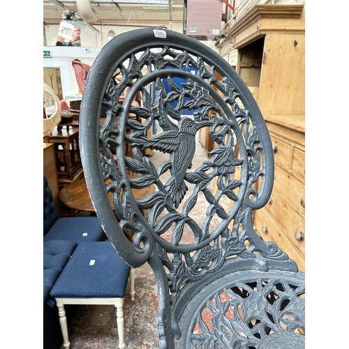 20 - A Victorian style grey painted cast metal patio table and chair - table approx. 66cm high x 71cm dia... 