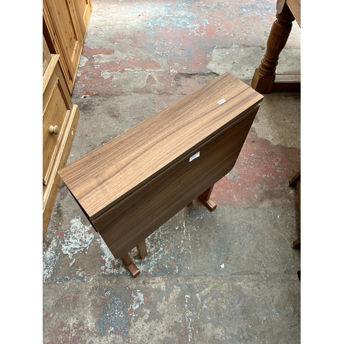 31 - A mid 20th century teak effect and beech drop leaf gate leg kitchen table