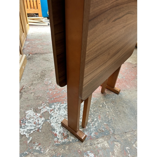 31 - A mid 20th century teak effect and beech drop leaf gate leg kitchen table