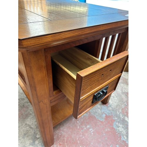 32 - A modern oak three tier coffee table with single drawer