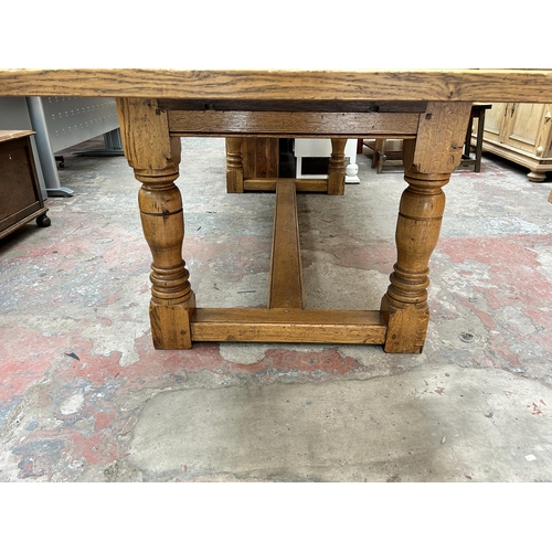 33 - A 17th century style solid oak refectory dining table - approx. 77cm high x 91cm wide x 244cm long