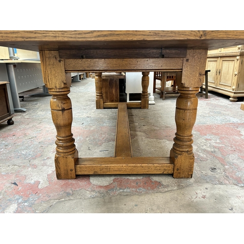 33 - A 17th century style solid oak refectory dining table - approx. 77cm high x 91cm wide x 244cm long