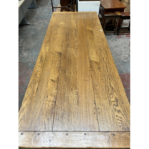 33 - A 17th century style solid oak refectory dining table - approx. 77cm high x 91cm wide x 244cm long