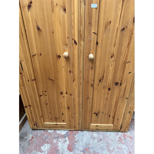 35 - A pine double wardrobe - approx. 187cm high x 120cm wide x 57cm deep