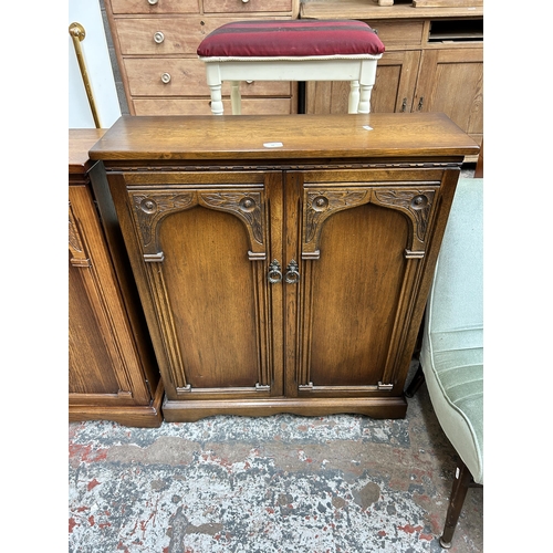 44 - Two carved oak media cabinets