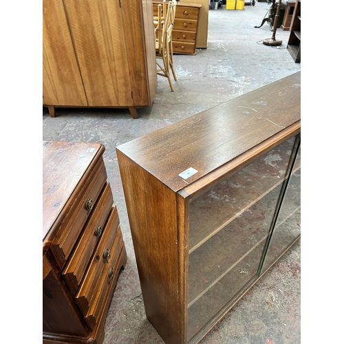 49 - A mid 20th century Gordon Russell teak bookcase with two glass sliding doors