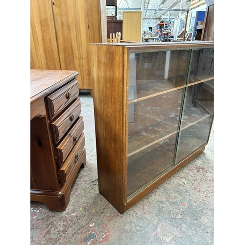 49 - A mid 20th century Gordon Russell teak bookcase with two glass sliding doors