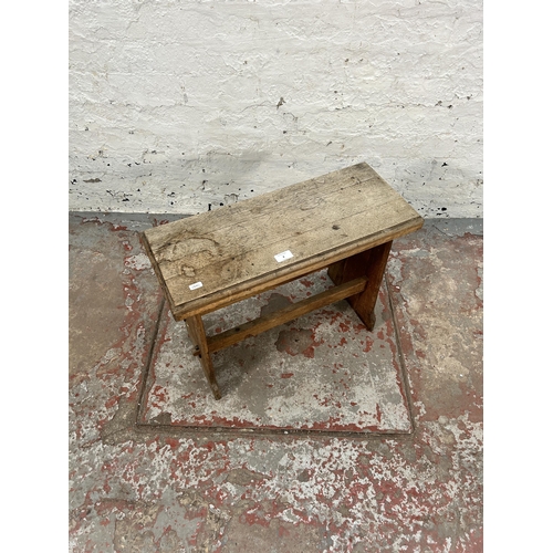 8 - A 19th century style oak farmhouse stool - approx. 44cm high x 60cm wide x 25cm deep