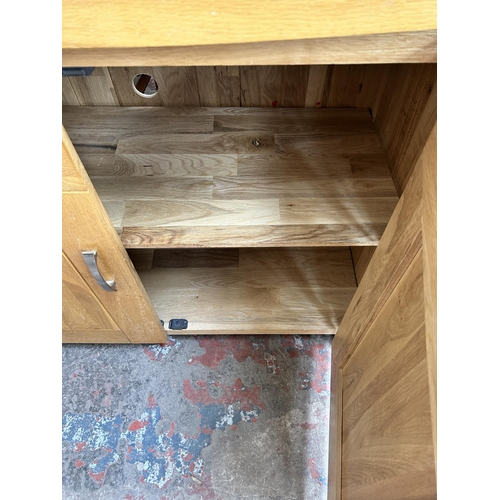 81 - A modern oak sideboard - approx. 86cm high x 110cm wide x 45cm deep