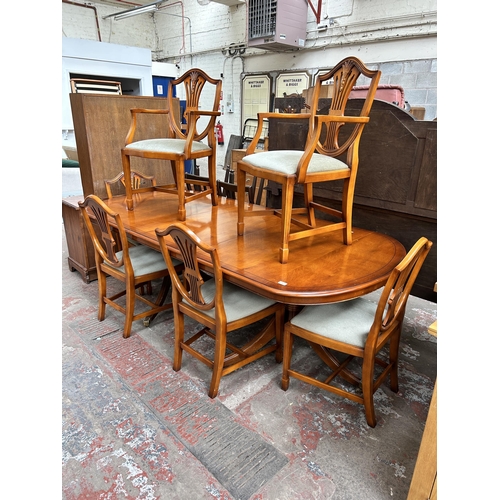 82 - A Bradley yew wood twin pedestal extending dining table and six dining chairs - approx. 77cm high x ... 