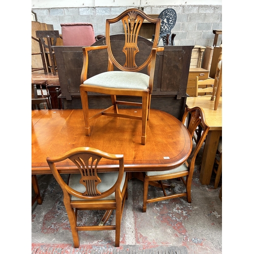 82 - A Bradley yew wood twin pedestal extending dining table and six dining chairs - approx. 77cm high x ... 