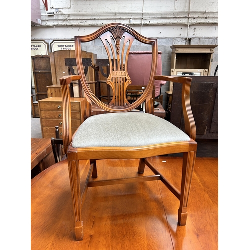 82 - A Bradley yew wood twin pedestal extending dining table and six dining chairs - approx. 77cm high x ... 