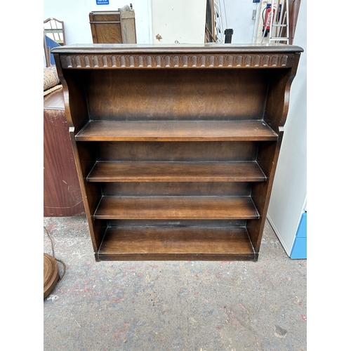 90 - An oak four tier open bookcase - approx. 109cm high x 92cm wide x 23cm deep