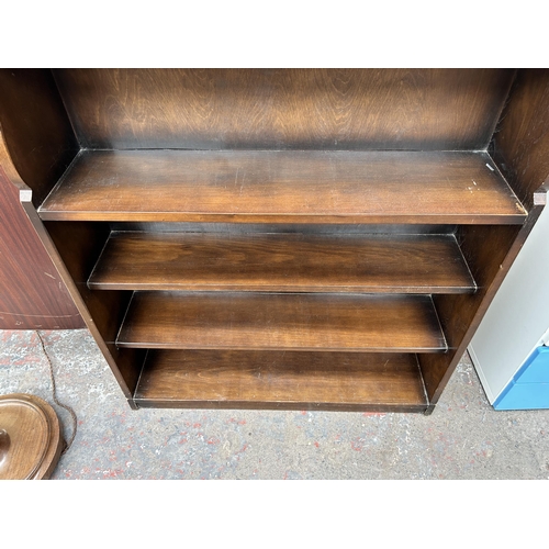 90 - An oak four tier open bookcase - approx. 109cm high x 92cm wide x 23cm deep