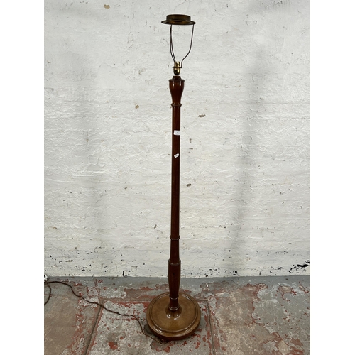 91 - A mahogany standard lamp with circular base - approx. 170cm high