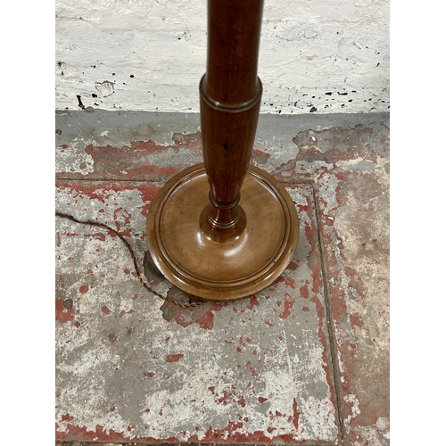 91 - A mahogany standard lamp with circular base - approx. 170cm high