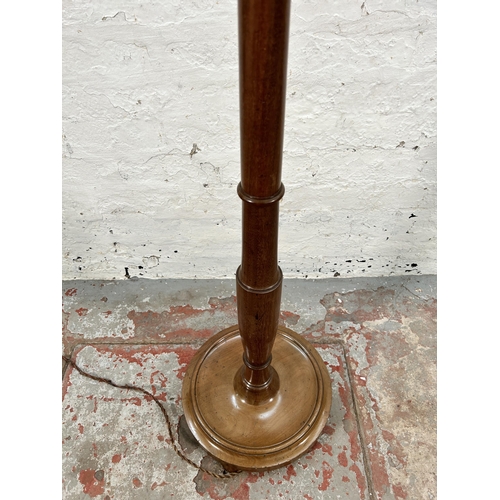 91 - A mahogany standard lamp with circular base - approx. 170cm high