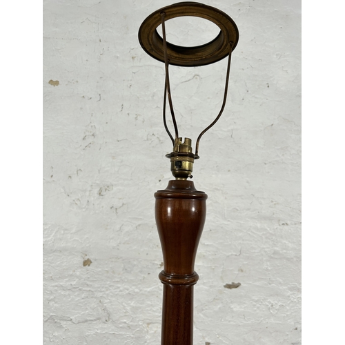 91 - A mahogany standard lamp with circular base - approx. 170cm high