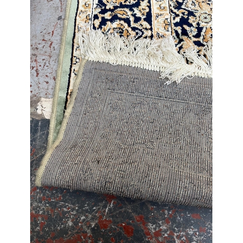 206 - A Middle Eastern green floral pattern rug - approx. 185cm x 133cm