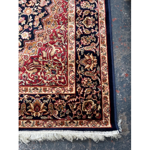 207 - A Middle Eastern blue floral pattern rug - approx. 185cm x 133cm