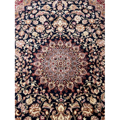 207 - A Middle Eastern blue floral pattern rug - approx. 185cm x 133cm