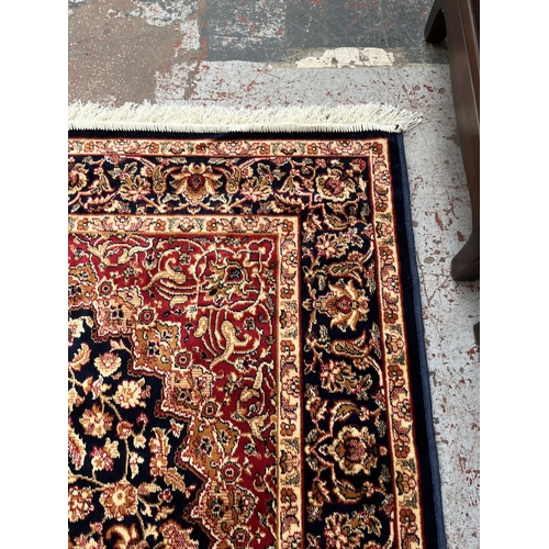 207 - A Middle Eastern blue floral pattern rug - approx. 185cm x 133cm