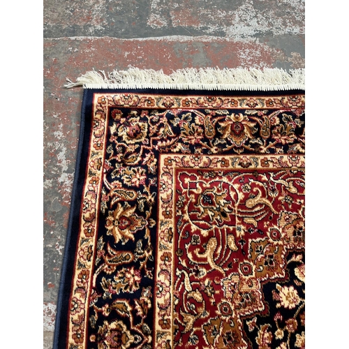 207 - A Middle Eastern blue floral pattern rug - approx. 185cm x 133cm