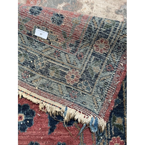 27 - A hand knotted rug - approx. 154cm x 100cm