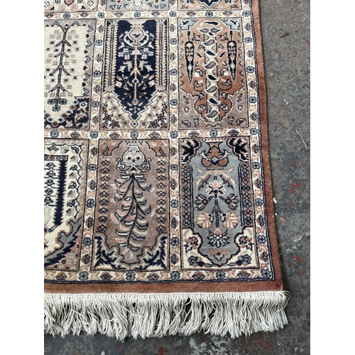 93 - A 100% wool pile rug made in Pakistan - approx. 165cm x 96cm