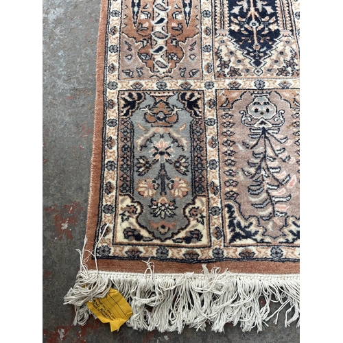 93 - A 100% wool pile rug made in Pakistan - approx. 165cm x 96cm