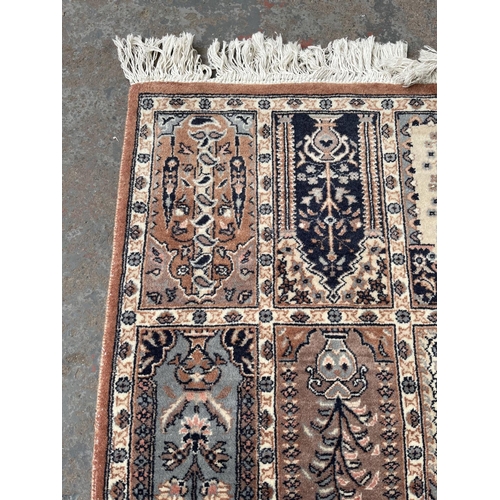 93 - A 100% wool pile rug made in Pakistan - approx. 165cm x 96cm