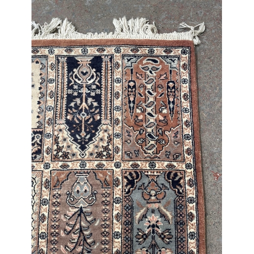 93 - A 100% wool pile rug made in Pakistan - approx. 165cm x 96cm