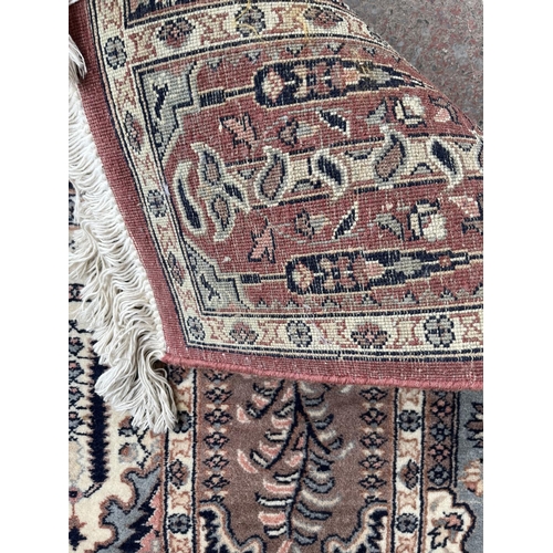 93 - A 100% wool pile rug made in Pakistan - approx. 165cm x 96cm