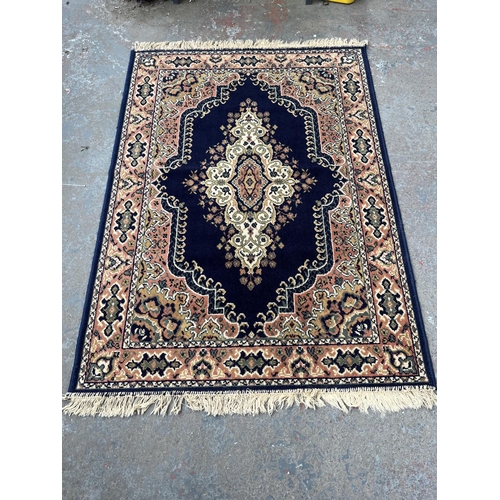 94 - A blue floral pattern rug - approx. 168cm x 121cm