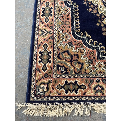 94 - A blue floral pattern rug - approx. 168cm x 121cm