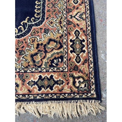 94 - A blue floral pattern rug - approx. 168cm x 121cm