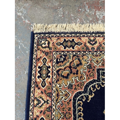 94 - A blue floral pattern rug - approx. 168cm x 121cm