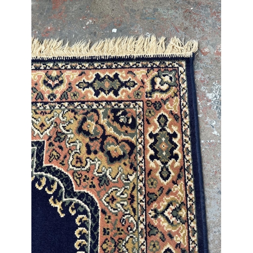 94 - A blue floral pattern rug - approx. 168cm x 121cm