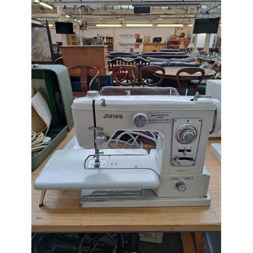 691 - A cased Jones electric sewing machine with foot pedal and instruction manual