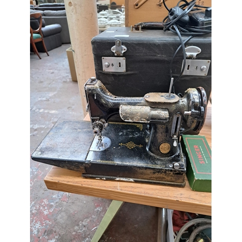 694 - Four items, one cased Singer featherweight portable electric sewing machine for spares or repair, on... 