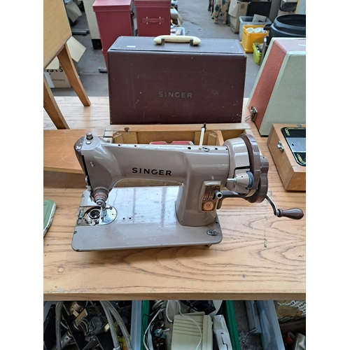 694 - Four items, one cased Singer featherweight portable electric sewing machine for spares or repair, on... 