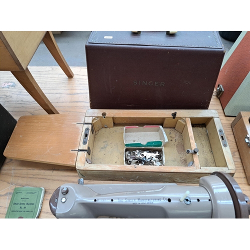 694 - Four items, one cased Singer featherweight portable electric sewing machine for spares or repair, on... 