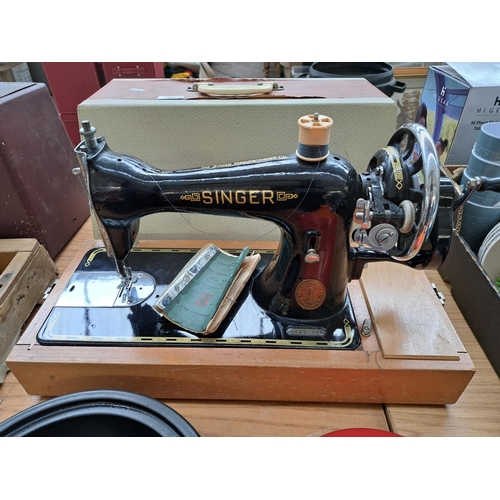 695 - A cased Singer manual sewing machine