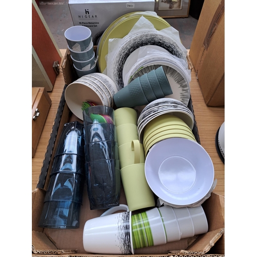 697 - A large collection of plastic camping dinnerware to include boxed Hi Gear sixteen piece melamine set... 