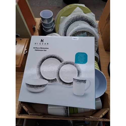 697 - A large collection of plastic camping dinnerware to include boxed Hi Gear sixteen piece melamine set... 