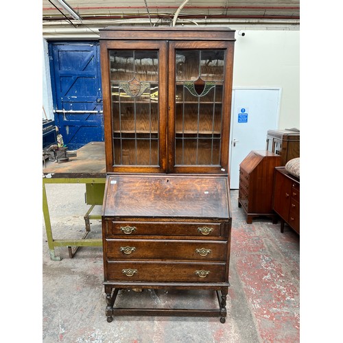 103A - An early 20th century oak bureau bookcase on barley twist supports - approx. 98cm high x 87cm wide x... 