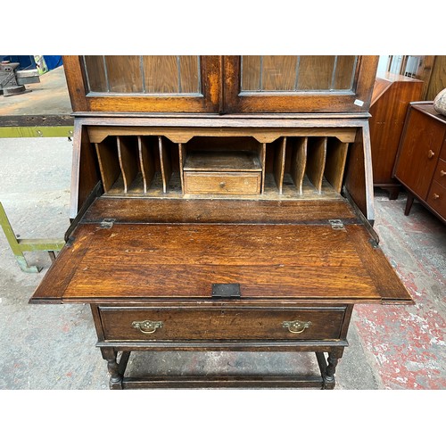 103A - An early 20th century oak bureau bookcase on barley twist supports - approx. 98cm high x 87cm wide x... 