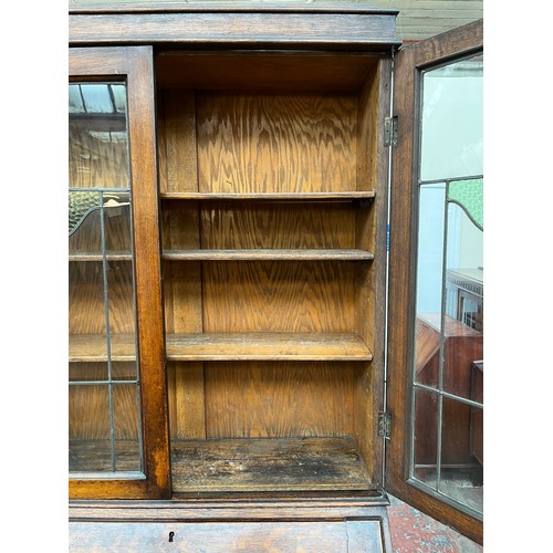 103A - An early 20th century oak bureau bookcase on barley twist supports - approx. 98cm high x 87cm wide x... 