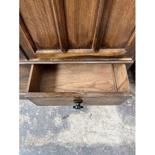 204 - An early 20th century mahogany bedside cabinet with later added glass top