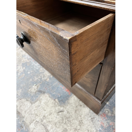 204 - An early 20th century mahogany bedside cabinet with later added glass top